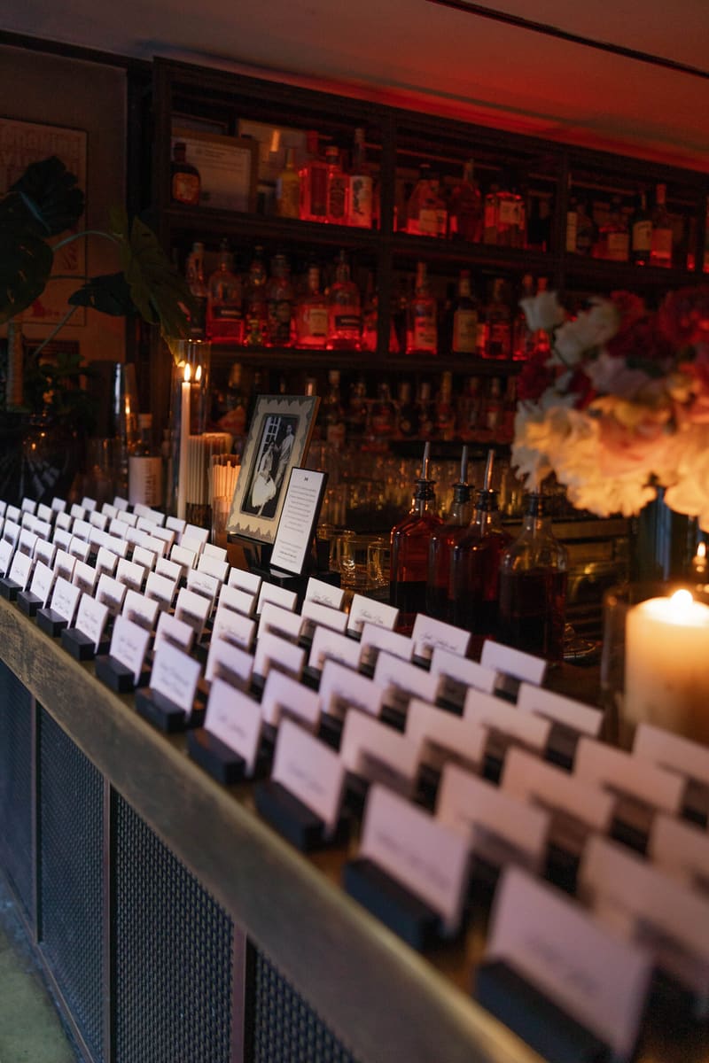 Rows of escort cards along the candlelit bar