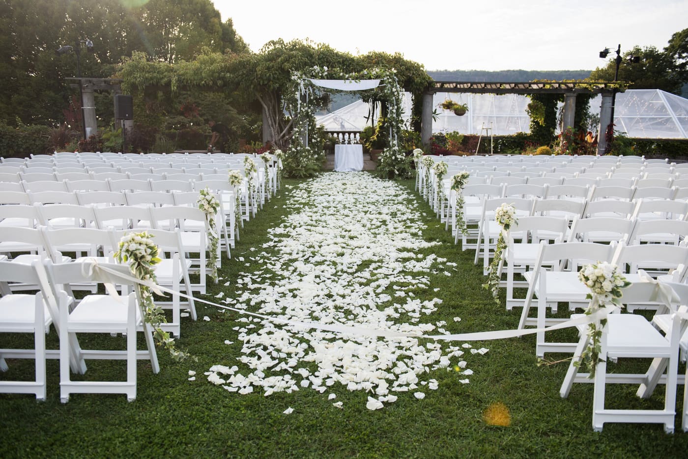 A petal-lined aisle before an outdoor ceremony