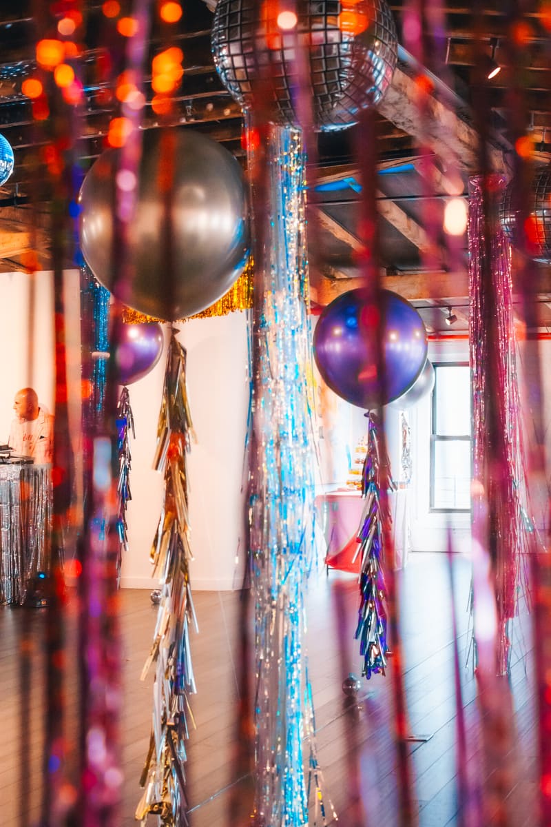 Tinsel streamers and giant balloons filling a loft
